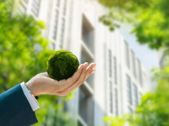 Environmental concept. Green globe in the hands of a businessman
