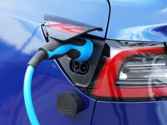 EV or Electric car at charging station with plug-in power supply cable